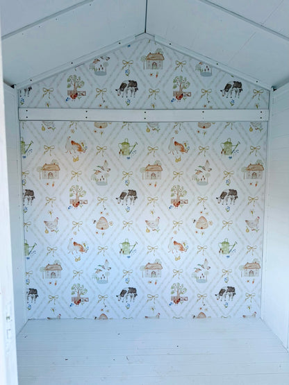Farm animal wallpaper installed inside a kids cubby house with a blue scalloped peg rail